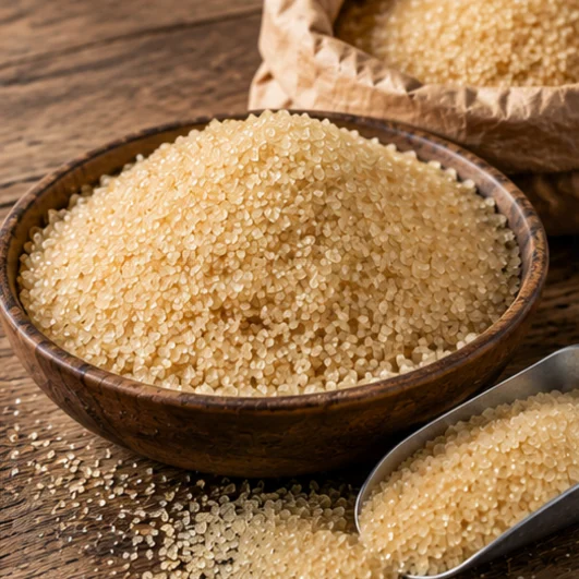 Light golden VHP raw cane sugar in a wooden bowl with a scoop